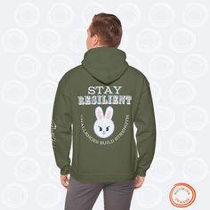 Leebit Lee Know "STAY Resilient" SKZoo Hoodie with Inspirational Quote | Stray Kids Unisex Hooded Sweatshirt for STAYs STAY inspired and cozy with this set of SKZoo hoodies, featuring your favorite Stray Kids characters alongside uplifting quotes featuring a reference to the best fans in the world. This collection of Rhyming Orange-designed hoodies are designed to empower every STAY and celebrate the incredible qualities of the group members. Made from a soft 50% cotton, 50% polyester blend, these Gildan unisex heavy blend hoodies provide comfort and style with a classic fit, double-lined hood, and kangaroo pocket. Perfect for expressing your love for SKZ while spreading positivity! Features: - Material: 50% cotton, 50% polyester - Fit: Unisex, classic fit with a double-lined hood - Ribbed Designed Hoodies, Kids Characters, Motivation For Kids, Motivational Hoodies, Spreading Positivity, Orange Design, Best Fan, Kpop Merch, Kid Character