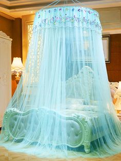 a canopy bed with mosquito netting over it in a bedroom setting that looks like a princess's castle