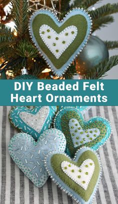 some heart ornaments hanging from a christmas tree with the words diy beaded felt heart ornaments