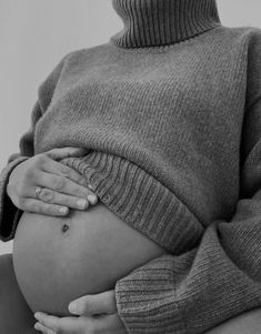 a pregnant woman with her hands on her belly