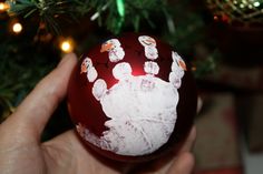 a handprinted ornament on a christmas tree