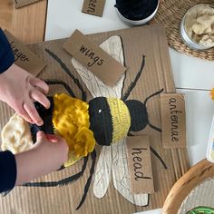 a child is making a bee craft out of cardboard