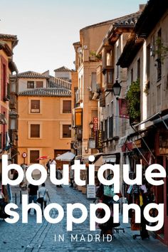 the words boutique shopping in madrid are overlaid by an image of people walking down a cobblestone street