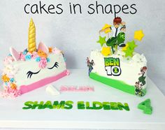 two cakes in the shape of unicorns on top of a white table with green lettering