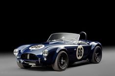 an old blue sports car with the number sixty on it