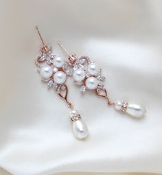 These lovely earrings I created using Premium cubic zirconia flower components and faux pearls. Crystal pearl dangle on bottom. Beautiful rose gold finish. Earrings dangle 2-3/8 inch and are 3/4 inch at their widest. Gorgeous sparkle !PLEASE ALLOW APPROX 5 BUSINESS DAYS FOR COMPLETION BEFORE SHIPPING. FOR MATCHING PIECES SIMPLY TYPE "MIA" IN THE SEARCH BAR Pearl Drop Bridal Earrings, Drop Bridal Earrings, Pearl Drop Earrings Bridal, Rose Gold Pearl, Search Bar, Gold Crystal, Lovely Earrings, Swarovski Pearls, Crystal Drop