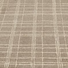 an area rug is shown with squares and lines on the ground, in neutral colors