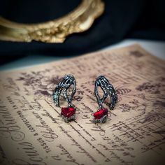 FREE SHIPPING on all orders $USD 35+ (USA) and $USD 45+ (WORLDWIDE) with Tracking.  Halloween Themed Skeleton Hands Red Heart Earrings. A Perfect Gift for Dark Romance Lovers.  ❤ Thank you for dropping by Sonder Blue's little shop. Follow me on Instagram: @sonderblue.jewelry to see how I handmake each jewelry piece and subscribe to my Newsletter for exclusive coupons and updates: https://linktr.ee/blueslittleworkshop ❤ Skeleton Hand Earrings, Gothic Metal Earrings For Valentine's Day, Red Punk Earrings For Gifts, Red Gothic Earrings For Pierced Ears, Gothic Red Nickel-free Earrings, Halloween Party Heart-shaped Earrings, Heart-shaped Halloween Party Earrings, Red Metal Halloween Earrings, Red Pierced Halloween Earrings