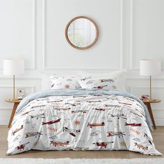 the comforter is made up with airplanes on it