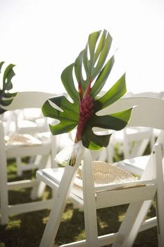 two white chairs with red and green flowers on them