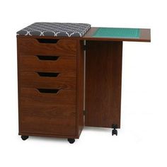 a wooden desk with three drawers on wheels