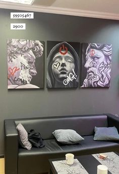 three paintings hang on the wall above a couch