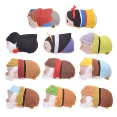 a group of stuffed animals with hats and scarves on their heads, all in different colors