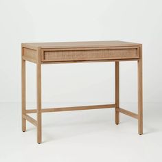 a wooden desk with a drawer on one side and an open drawer on the other