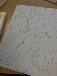 a drawing of a flower with the word kiss written on it next to some markers