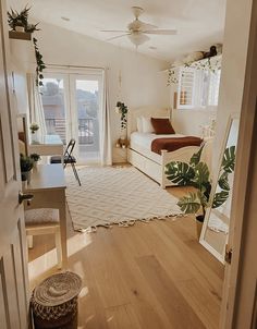 an open door leading to a bedroom with two beds and a desk in the corner