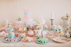 a table topped with lots of cakes and desserts