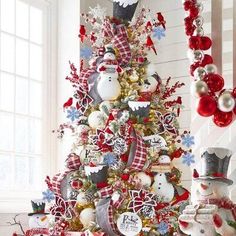 a christmas tree decorated with red, white and blue ornaments