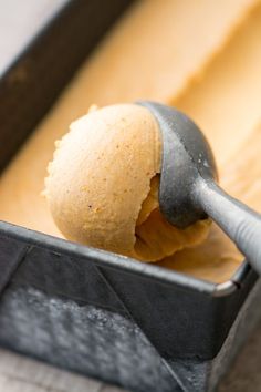 a scoop of ice cream in a pan with a spoon sticking out of the top