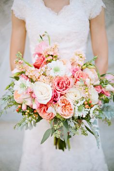 a bride holding a bouquet of flowers in her hands