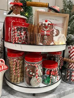 christmas cookies, candy canes and candies in glass jars on a round shelf