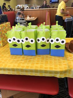 some paper bags are sitting on a table in front of people at a dining room