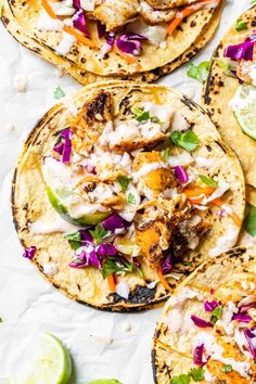 chicken tacos with cole slaw and avocado salsa on top, served in tortilla shells