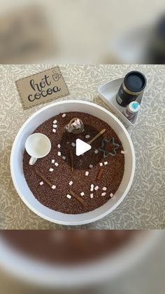 a white bowl filled with chocolate and marshmallows on top of a table