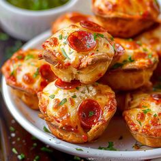 mini pizzas are stacked on top of each other with cheese and pepperoni in the middle