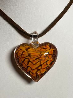 orange peach heart shaped Murano inspired glass pendant, clavicle, necklace pendant width 1 3/8 inches / 3.5 cm pendant height 1 9/16 inches / 4 cm comes with a dark brown suede cord 18-19.5 inches/46-49.5 cm will be shipped with a gift bag this item makes such a unique gift the 3D orange peach striped glass heart perfect gift for birthdays, Valentines, Christmas, Easter or any occasion Please have a look at the other items in my store. I ship all multi-item purchases in the same package. You wi Orange Heart Charm Jewelry, Heart-shaped Orange Necklace For Gift, Handmade Orange Heart-shaped Jewelry, Handmade Orange Glass Necklace, Heart-shaped Glass Necklace, Peach Orange, Suede Cord, Glass Heart, Brown Suede