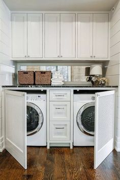 a white washer and dryer sitting inside of a laundry room next to each other