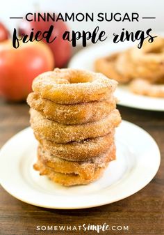 cinnamon sugar fried apple rings stacked on top of each other with apples in the background