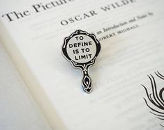 a close up of a book with a pin on it