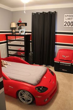 a red sports car bed in a boys bedroom