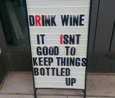 a sign that says drink wine it isn't good to keep things bottled up