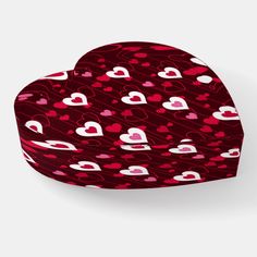 a red heart shaped box with hearts on the front and sides, all over it