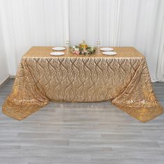 a gold table cloth on top of a wooden floor