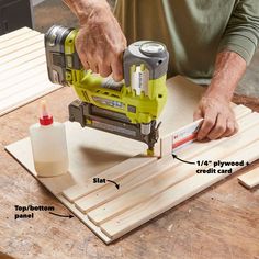 a man sanding wood with a power tool