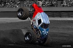 a monster truck is in the air with it's front wheels up and its tires down