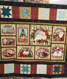 a quilted wall hanging with pictures of santa and other christmas related items on it