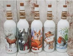 four bottles with animals painted on them sitting next to each other