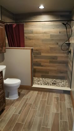 a bathroom with wooden floors and tile walls