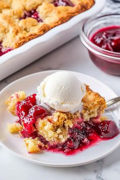 a piece of pie on a white plate with ice cream and cranberry sauce