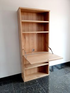 a wooden desk with shelves on the wall