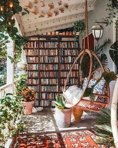 a room filled with lots of books and plants