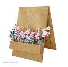 a wooden easel with pink and white flowers in it