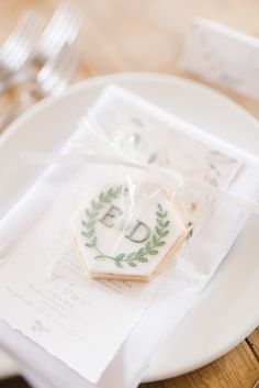 some cookies are sitting on a plate with napkins and silverware in the background