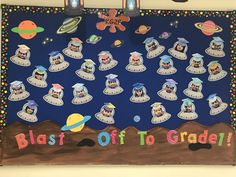 a bulletin board with pictures of different planets and the words blast off to grade on it