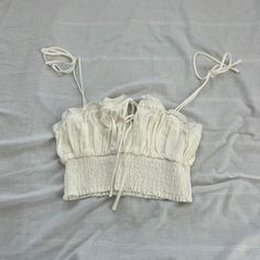 Princess Polly Crop Top Size 4 Condition: Nwot Color: White Details : - Smocked Bottom - Lined - Self-Tie Sleeves Extra: - I Ship Between 1-2 Days White Summer Tops With Drawstring, White Smocked Bodice Crop Top, Spring Cotton Smocked Crop Top, Spring Cotton Crop Top Smocked, White Fitted Crop Top With Smocked Back, Fitted White Crop Top With Smocked Back, Stretch Cotton Smocked Top For Vacation, Cotton Smocked Ruched Stretch Top, Spring Ruched Cotton Crop Top