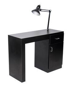 a black desk with a lamp on top